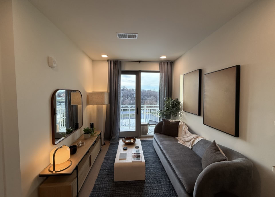 Nashville Apartment living room with floor to ceiling windows offering tons of natural light.