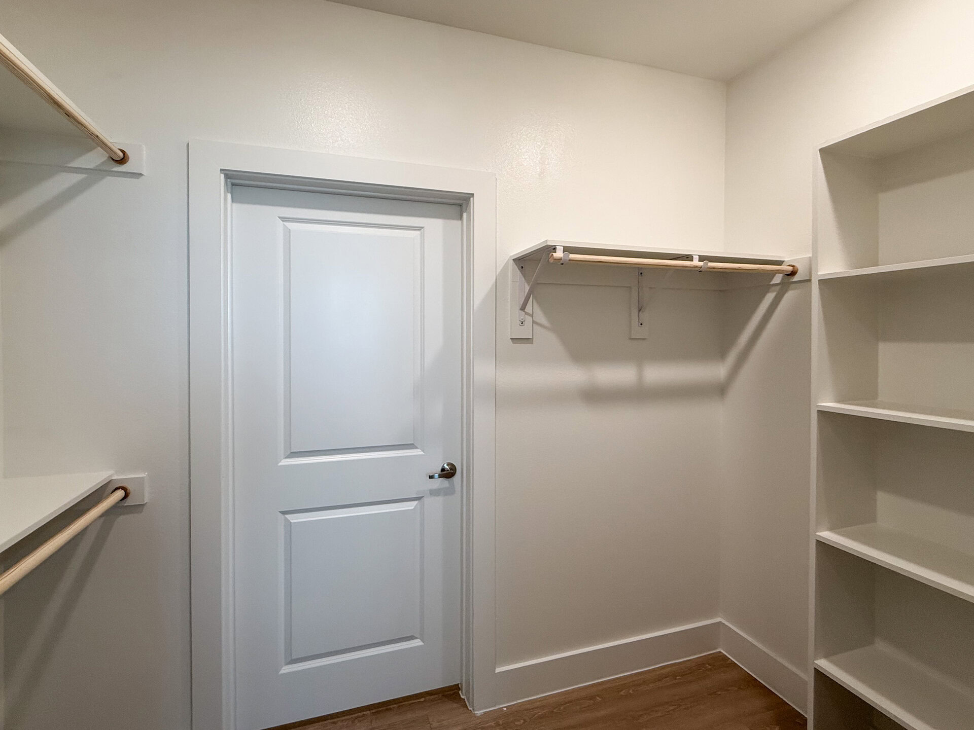 A modern San Antonio apartment closet with shelves and racks to hang clothes