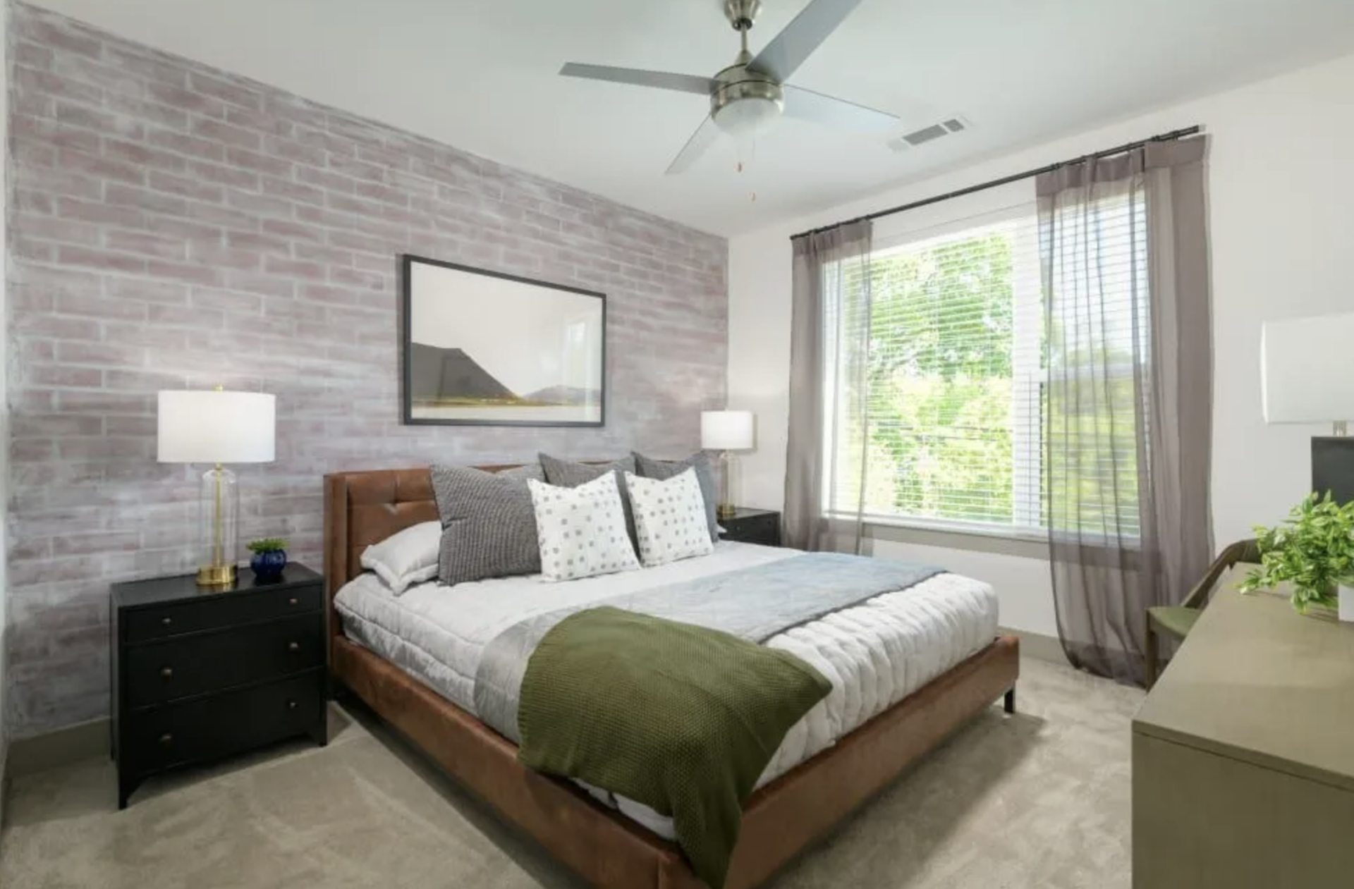 Atlanta Apartment bedroom with a large window and carpeted floors.
