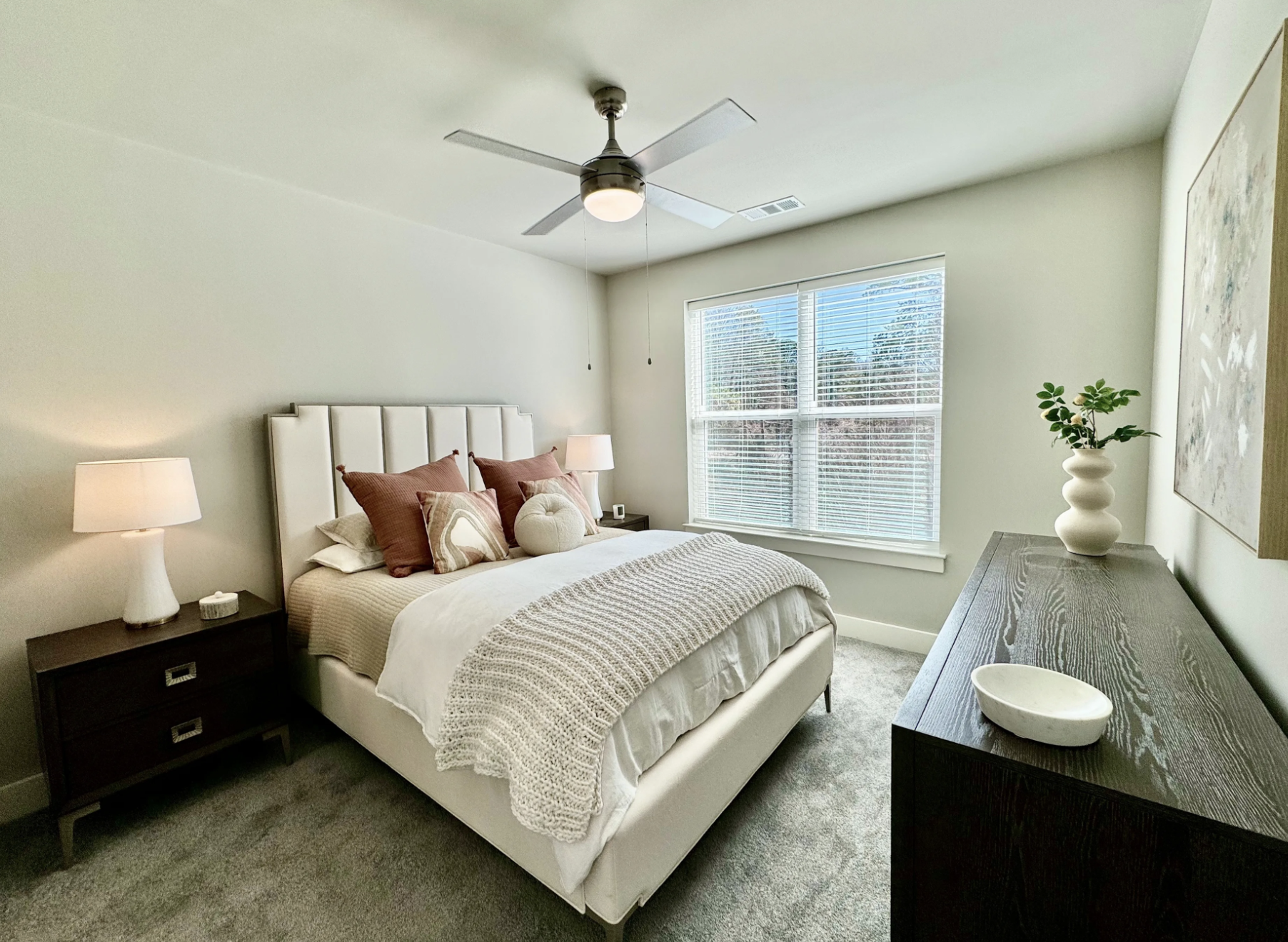Atlanta Apartment bedroom with carpeted floors and a large window.