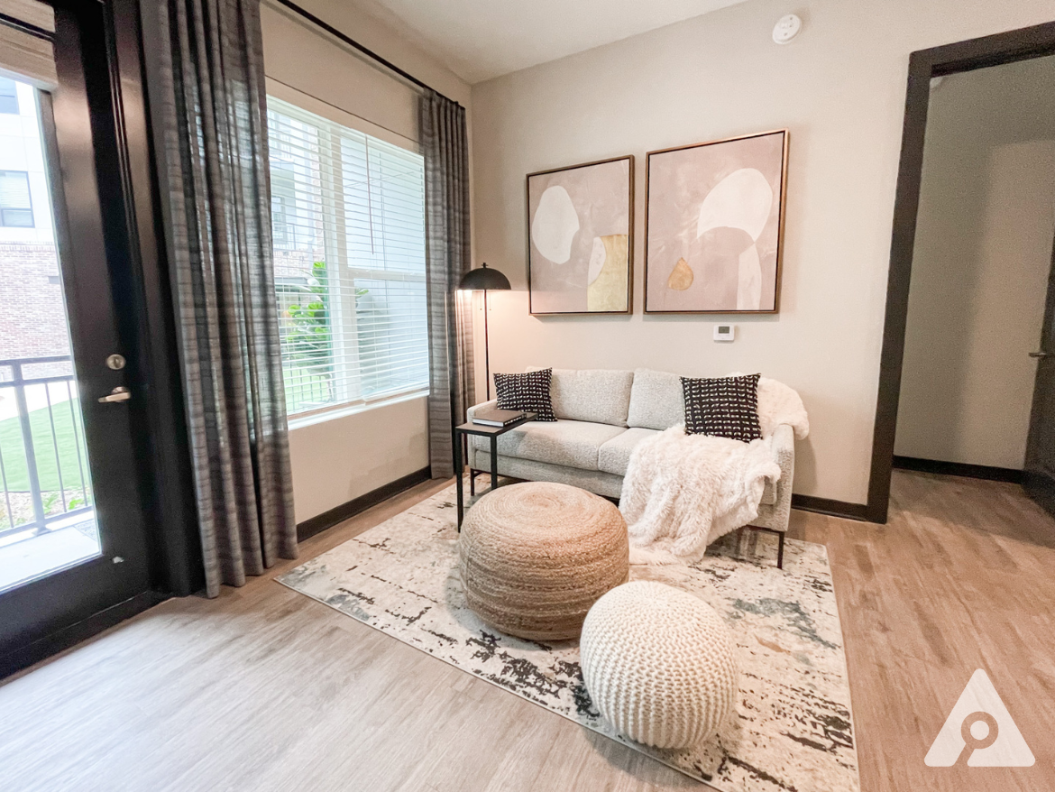 Atlanta Apartment living room with large windows and an attached balcony/patio.