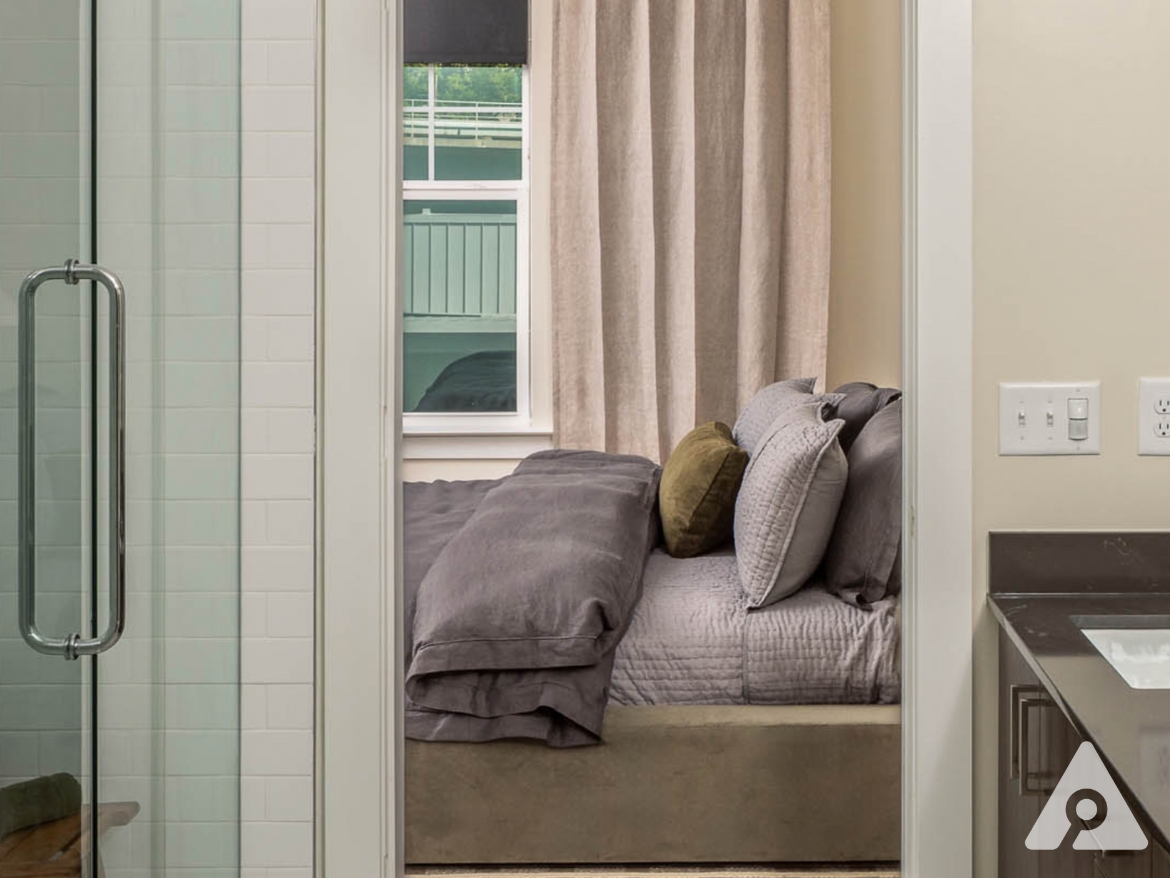 Atlanta Apartment bathroom with a walk in shower and brown cabinets.