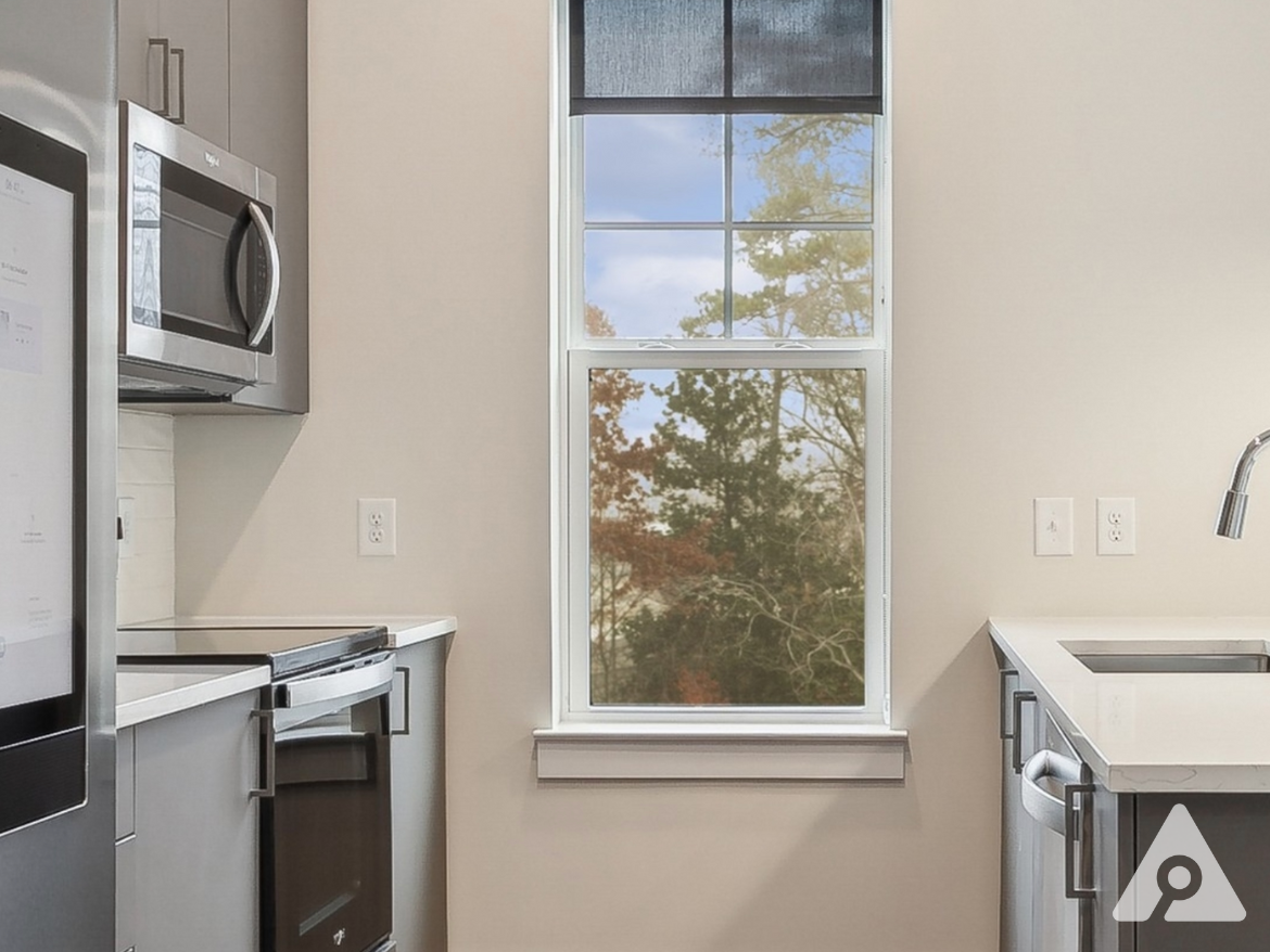 Atlanta Apartment kitchen with grey cabinets and updated appliances including a smart fridge.