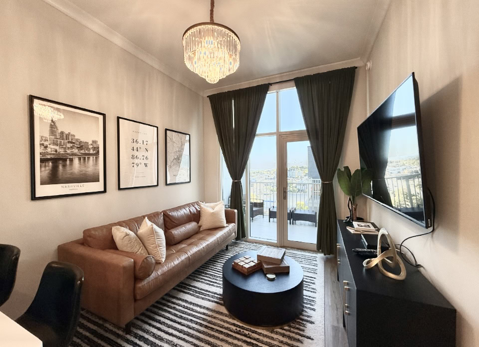 Nashville Apartment living room with floor to ceiling windows.