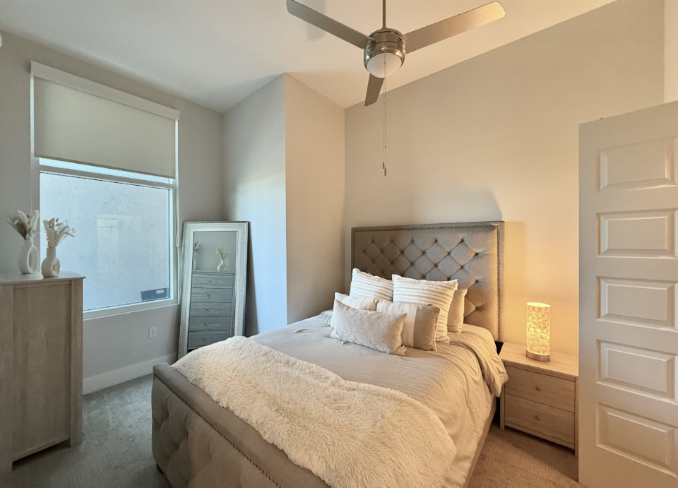 Nashville Apartment bedroom with carpeted floors and a large window.