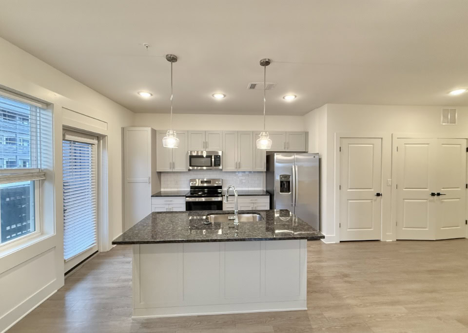 Nashville Apartment kitchen with a large island, stainless steel appliances, and an open concept design.