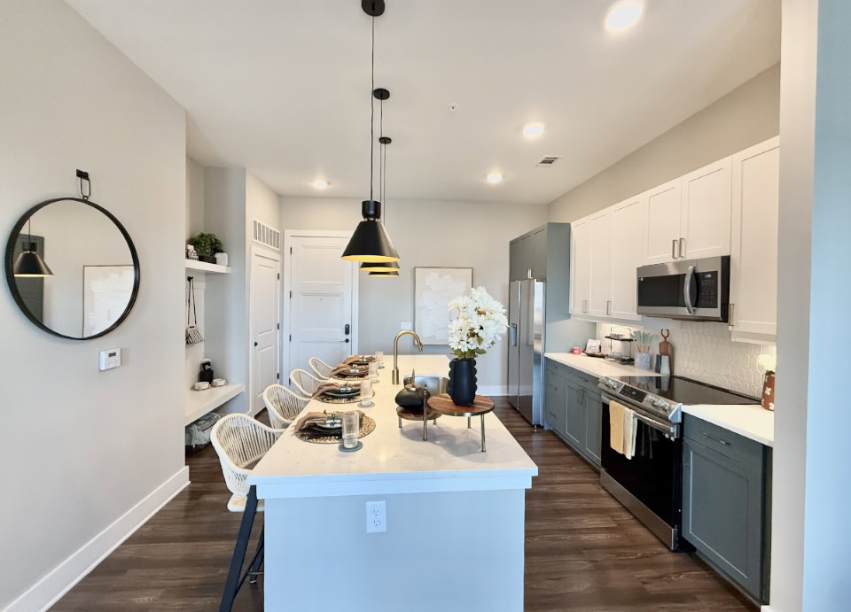 Atlanta Apartment kitchen with a large island and two tones cabinets.