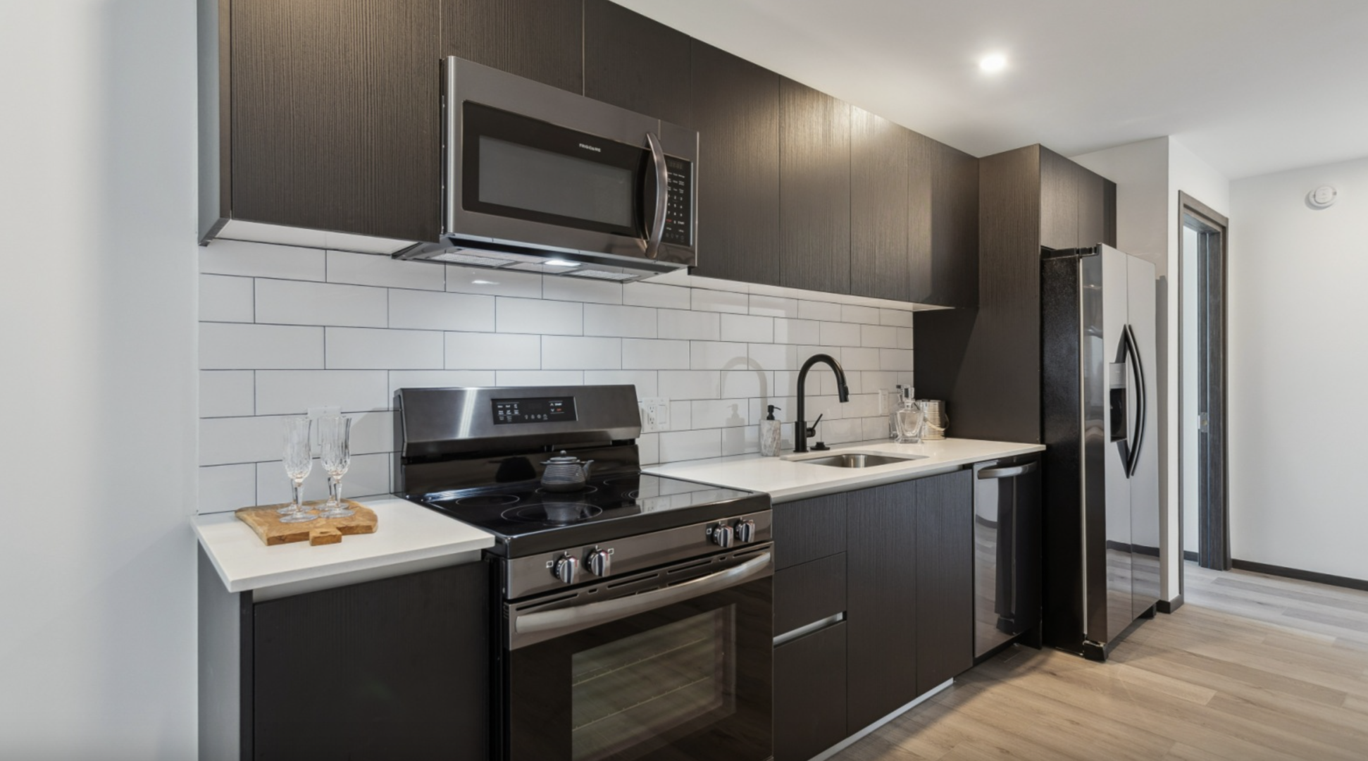 Nashville Apartment kitchen with brown cabinets and stainless steel appliances.