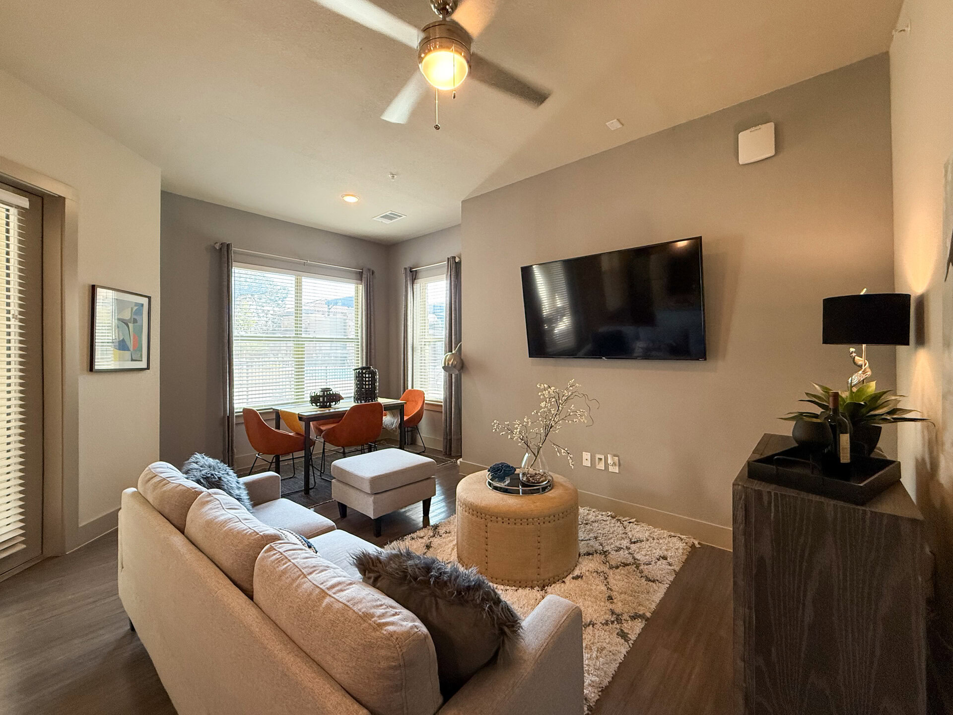 A cozy San Antonio apartment living room features natural sunlight, spacious open layout, and a modern aesthetic.
