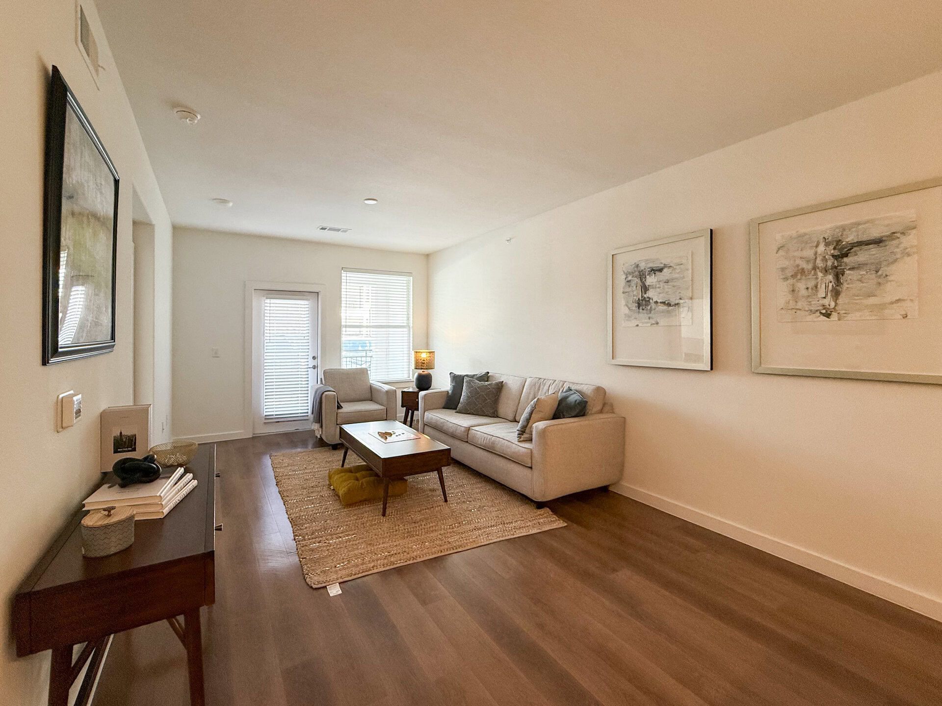 A modern San Antonio apartment living room features spacious living area for plenty of furniture and flex space. The space has a bright, airy feel with natural light coming through the windows.