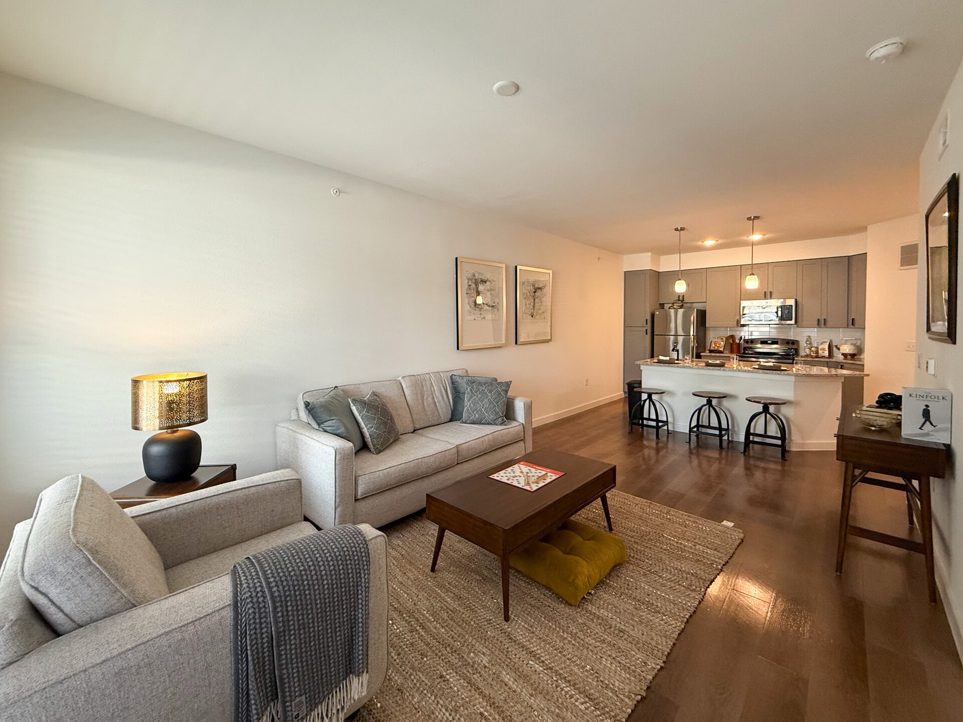 A modern San Antonio apartment features an open-concept layout. The flooring is a warm wood tone that adds comfort to the space.