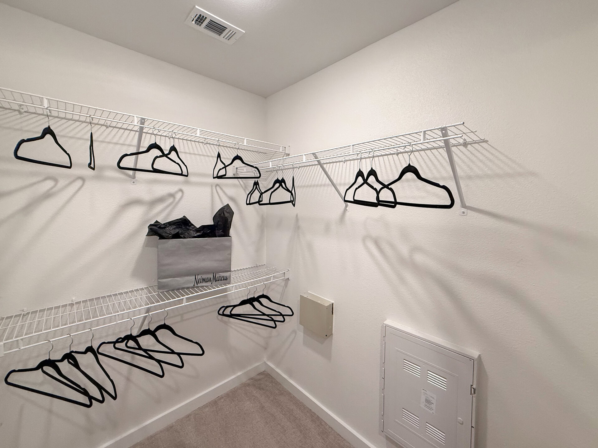 A Northwest San Antonio apartment closet with several white wire shelves.