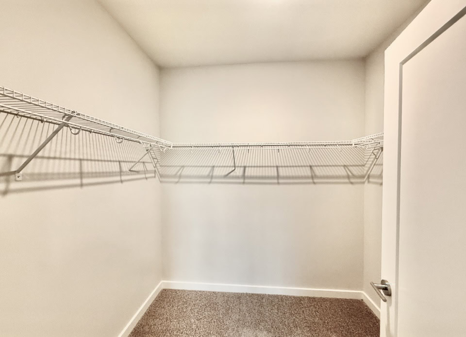 Nashville Apartment walk in closet with organization racks.