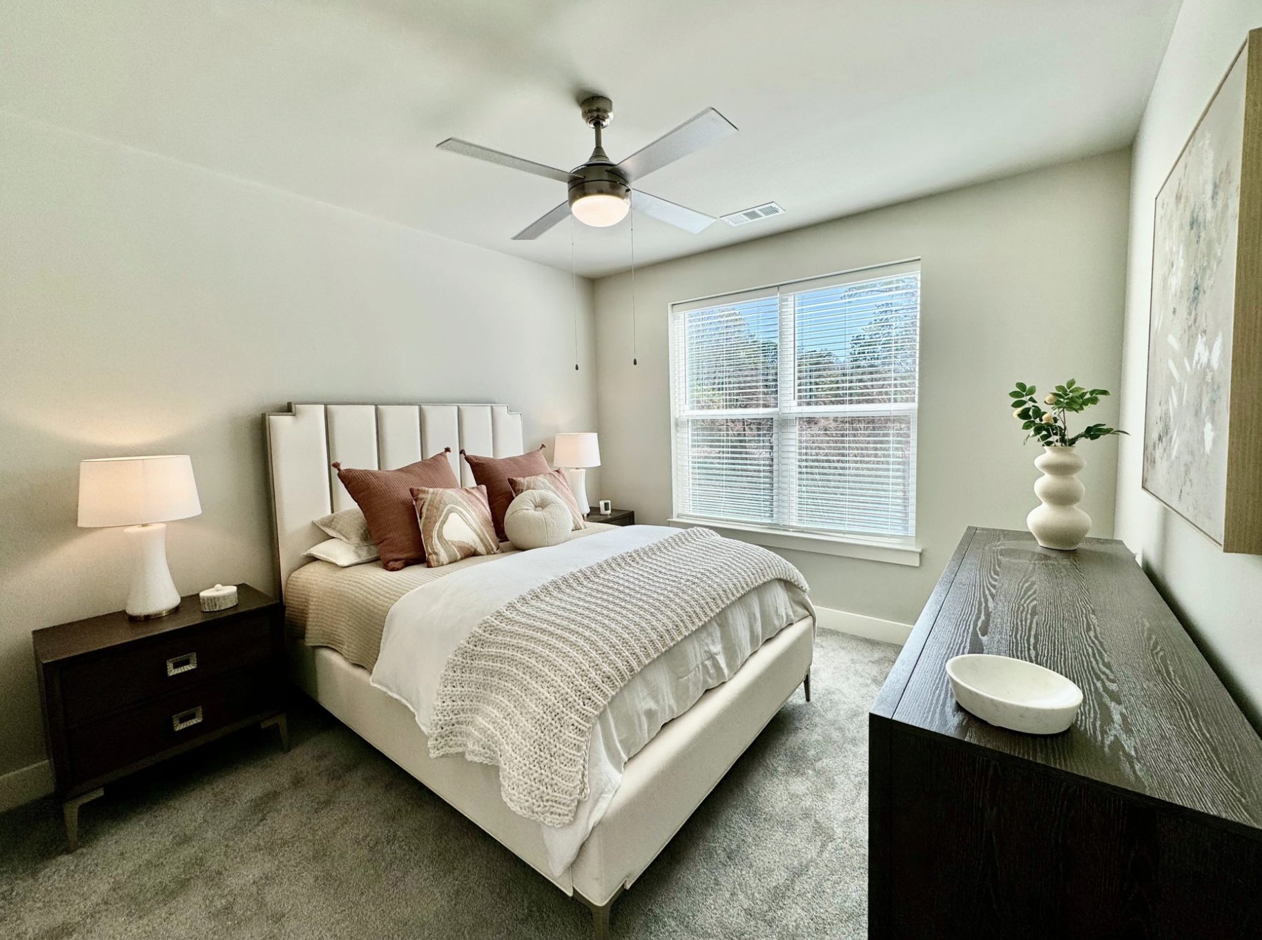 Atlanta Apartment bedroom with carpeted floors and a large window.