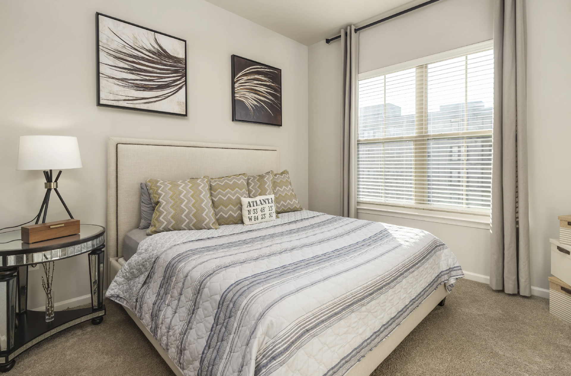 Atlanta Apartment bedroom with tall ceilings and a large window.