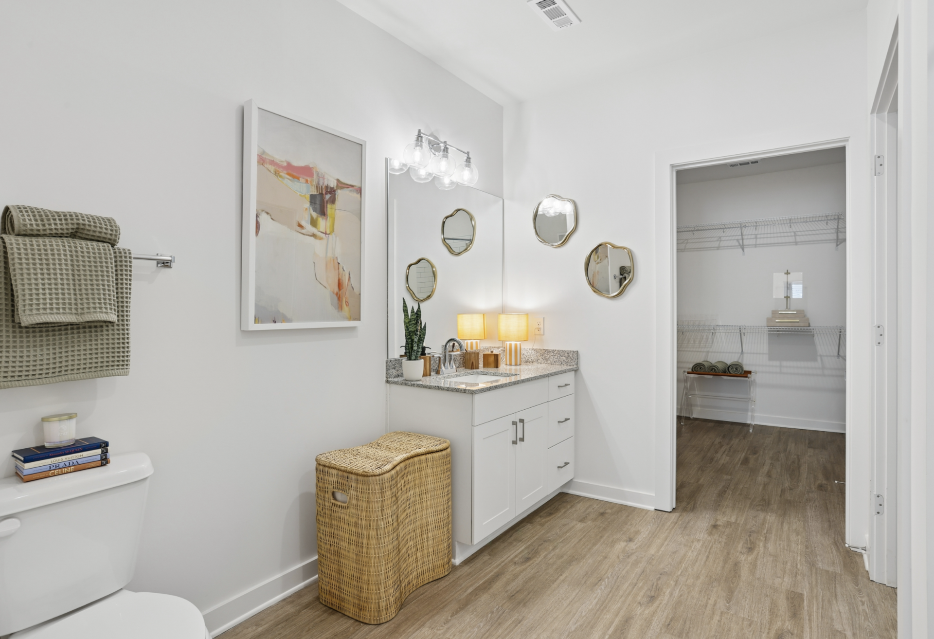 Atlanta Apartment bathroom with white cabinets, plenty of room, and a bath tub.